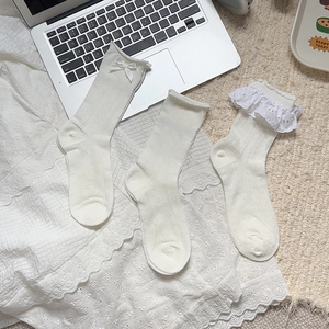 Detailed macro view of cream Lolita socks featuring delicate lace bows and knit textures