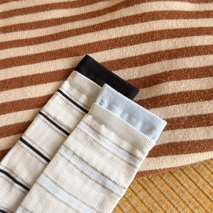 Detail view of cotton striped socks with ribbed cuffs and breathable knit texture