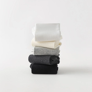 Vertical stacks of premium ribbed cotton socks in white beige grey and black tones