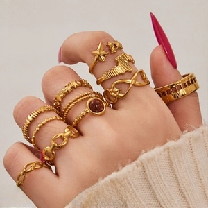 Bohemian gold ring set with star and gemstone details on hand with knit sleeve