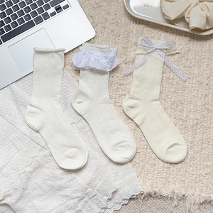 Detailed view of Lolita style lace bow socks with hollow mesh and vintage frills