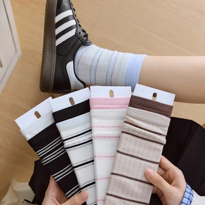 Detail of assorted striped cotton socks set in four colors with high elastic knit texture