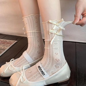 Detail of lace socks with heart hollow patterns and ribbons paired with ballet flats