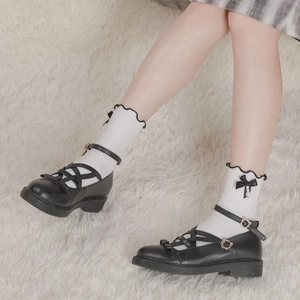 Lolita style white ruffle socks with black lace trim and pearls worn with Mary Jane shoes