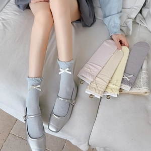 Detail of breathable ribbon bow crew socks with ruffled cuffs in various pastel colors