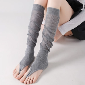 Detail of grey knitted leg warmers with breathable open-toe stirrup design for summer comfort