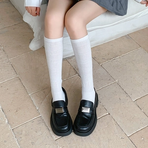 Japanese style white ribbed knee high socks with black platform loafers for women