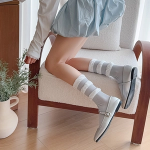 Detail von grau-weiß gestreiften Rüschensocken mitバレエ-Stil Spitzenbesatz am Saum