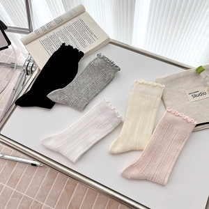 Detailed view of five colors ruffle edge socks with vertical stripes in preppy style