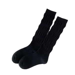 Minimalist black calf-high socks with bubble knit texture in breathable cotton fabric