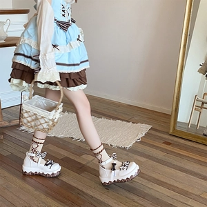 Detail of sweet Lolita socks with heart texture and lace frills on platform shoes