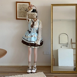 Detail of sweet Lolita-style dress featuring layered ruffles and cherry bow accents