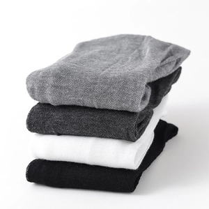 Detail showing stacked breathable knit leg warmers in black, white, and grey colors