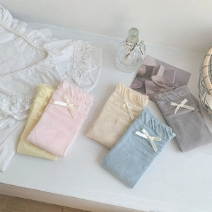 Detail of five pastel crew socks with lace trim and elegant white ribbon bows