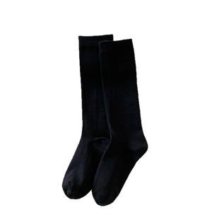 Classic black knee-high cotton socks in a minimalist solid design for school style