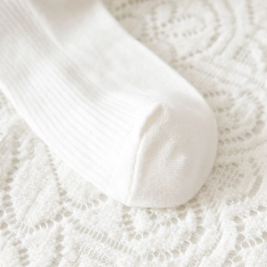 Detail of white Lolita socks showing fine rib knit texture and seamless toe stitching