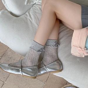 Detail of JK style ribbed crew socks featuring delicate bow accents and ruffled edges