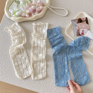 Close-up of floral lace mesh socks in cream and misty blue with delicate embroidery