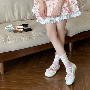 Detail of striped lolita socks featuring lace trim and cute bowknot accents
