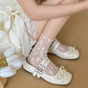 Sweet white lace floral socks paired with square toe Mary Jane shoes on wooden floor