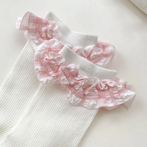 Macro detail of white ribbed socks featuring sweet pink gingham lace trim and wavy edges
