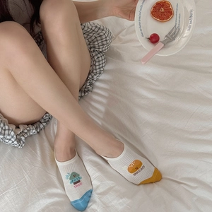 Detailed view of cute cartoon boat socks featuring asymmetrical tree and bread patterns