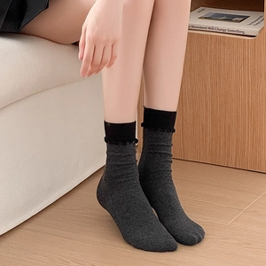 Chaussettes mi-hautes gris foncé avec bordure à volants noirs et texture tricotée douce