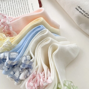 Detail of colorful cotton socks with plaid lace trim in pastel macaron tones