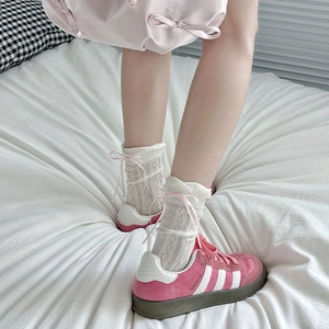 Sweet pink suede sneakers with white lace ribbon bow socks in a trendy Balletcore style