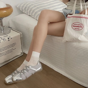 Silver ballet style flat shoes with breathable mesh panels and crisscross straps