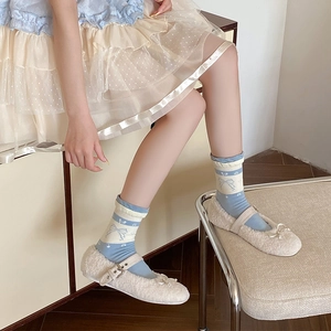Blue and cream vintage loose socks with bows paired with white furry Mary Jane shoes