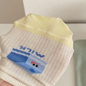 Detail of breathable mesh fabric and blue cartoon milk carton print on summer socks