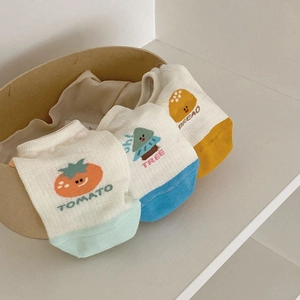 Detailed close-up of breathable knit cotton pet vests with colorful cartoon patterns