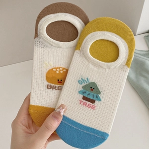 Detailed knit cotton texture of beige low-cut socks with cute bread and tree patterns
