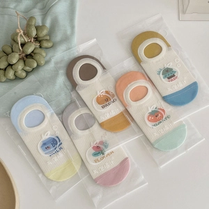 Close-up of five pairs of cartoon ankle socks in individual transparent gift packaging