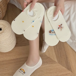 Close-up of beige cotton no-show socks with cute dog embroidery and polka dot patterns