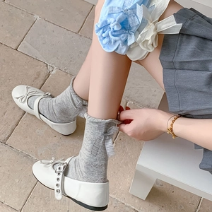Detail of sweet JK style mesh socks featuring ribbons, ruffles and hollow knit patterns
