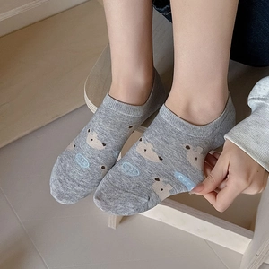 Detail shot of light grey low-cut socks featuring a cute cartoon brown bear pattern