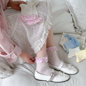 Détail de chaussettes hautes style ballet avec volants roses et plusieurs coloris pastel