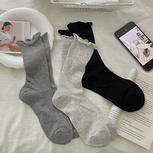 Detailed view of three-color ribbed socks set with elegant wavy ruffled edges and texture