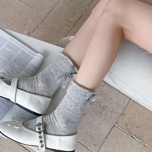 Grey mesh knit crew socks with sweet bow detail paired with Mary Jane shoes