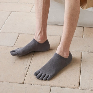 Macro shot of dark grey five-finger socks with breathable mesh texture and split-toe design
