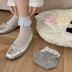 Detail of grey ribbed crew socks featuring various colorful lace ruffle trims and polka dots