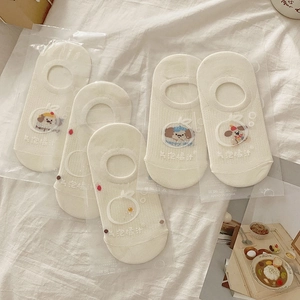 Detailed view of 5-pack white cotton low-cut socks with puppy embroidery in packaging