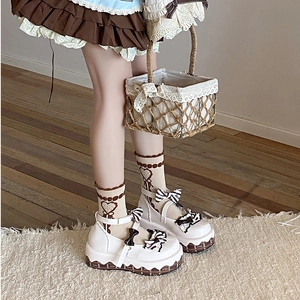 White platform Mary Jane shoes with bows and heart pattern socks in Lolita style