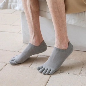 Close-up of men's low-cut five-toe socks in dark grey with breathable mesh texture