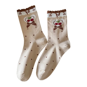 Beige lace socks with brown polka dots and cherry bow pattern in retro style
