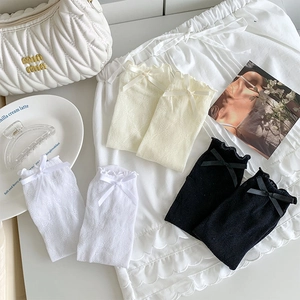Detailed lace pattern on mid-calf socks in white, beige and black with bow accents
