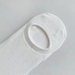 Close-up of white mesh knit fabric on breathable low-cut invisible socks for men