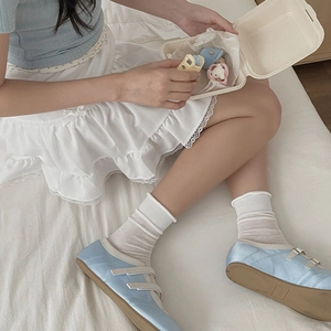 Light blue satin Mary Jane flats with ribbon straps and white knit crew socks for women